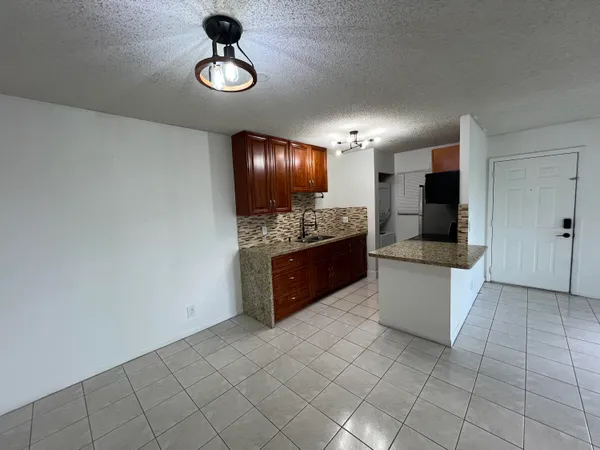 a kitchen with stainless steel appliances granite countertop a sink and a stove