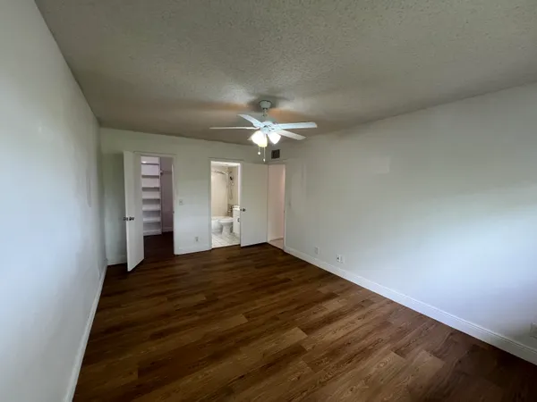 a view of a livingroom with a ceiling fan and window