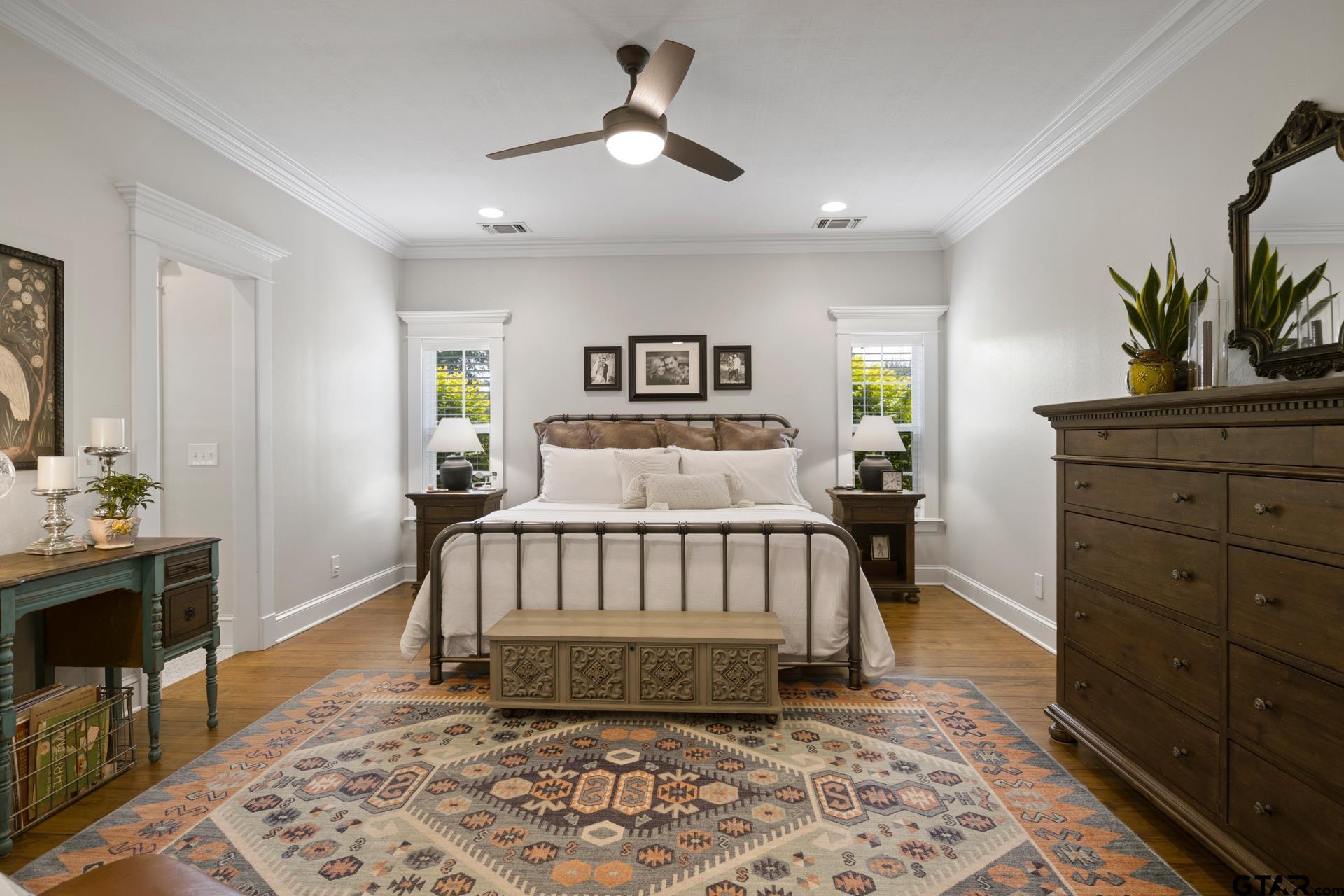 134 Private Road New Boston, TX 75570 - Photo 19 of 40 a bedroom with a bed and a chandelier