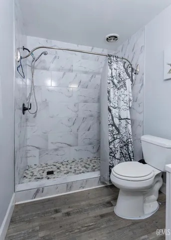 a white toilet sitting next to a bathroom sink