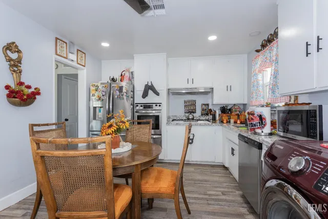 a dining room with furniture a fireplace and a flat screen tv