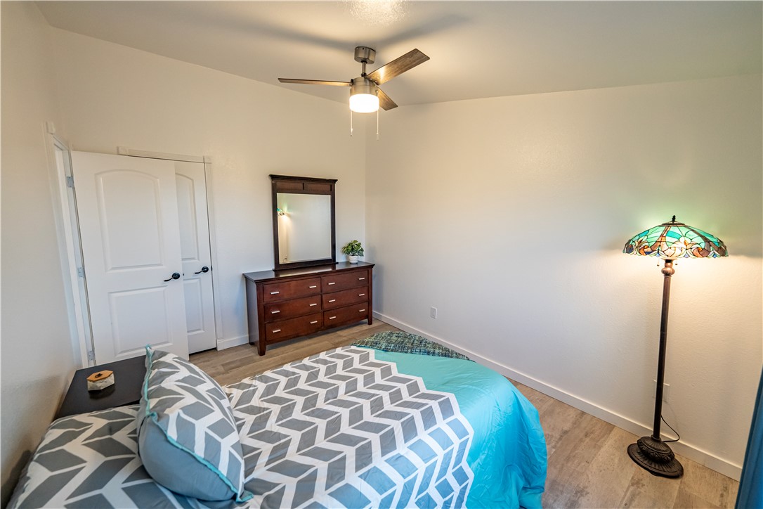 2765 North Silver Springs Road Kingman, AZ 86401 - Photo 23 of 60 a bedroom with a bed and a chandelier