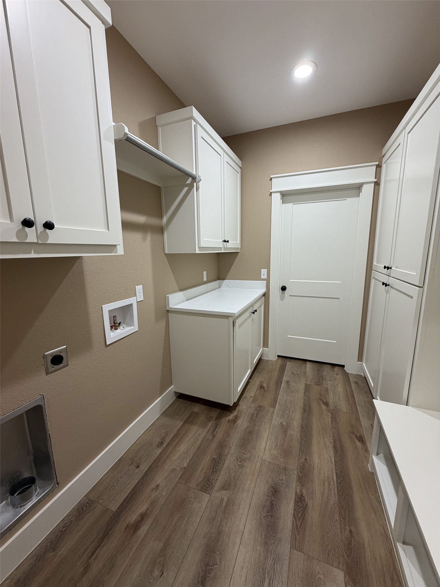 33 Wilderness Road North Calera, OK 74730 - Photo 13 of 39 Wood-finish flooring, recessed lighting, white shaker cabinetry, white countertop, and a built-in hanging rod