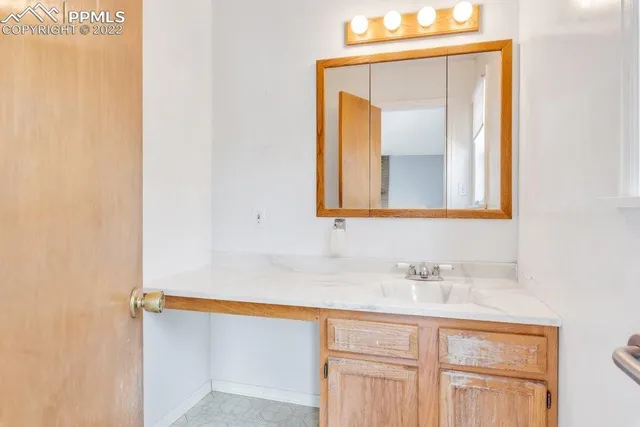 a view of an empty room with wooden floor and closet
