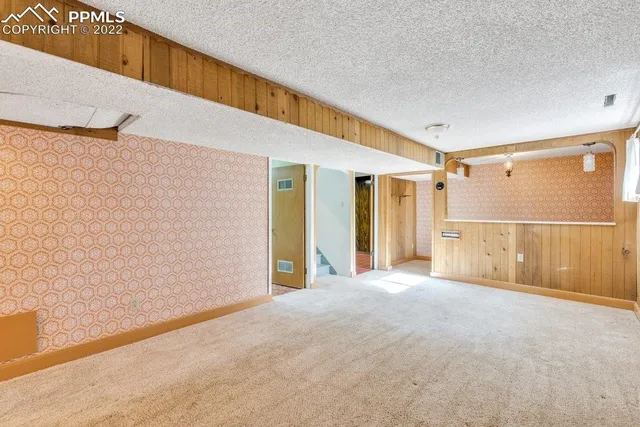 a view of a house with a tree in the background