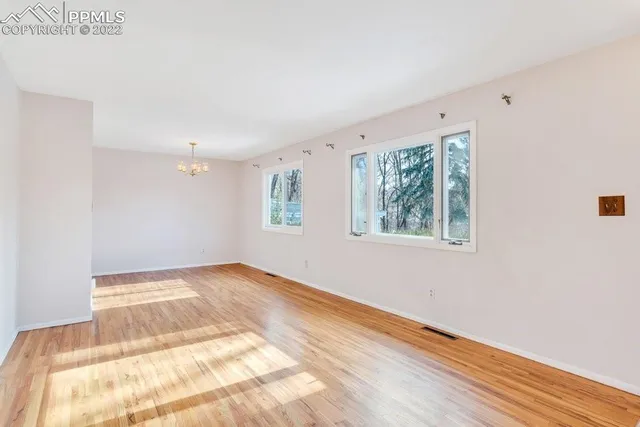a view of a livingroom with wooden floor and a staircase