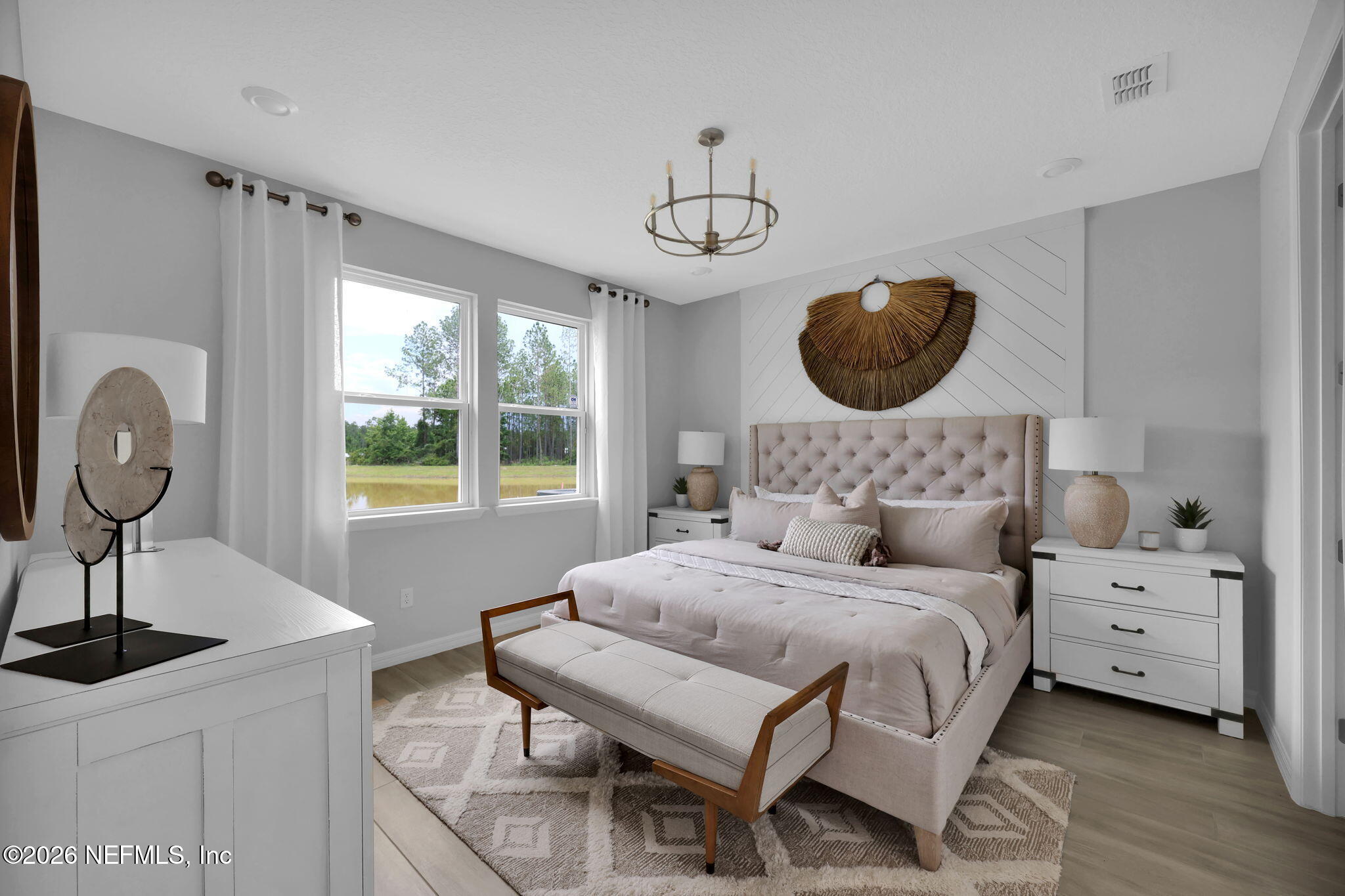 860 Rooster Holw Way Middleburg, FL 32068 - Photo 14 of 26 a bedroom with a bed a chandelier and window