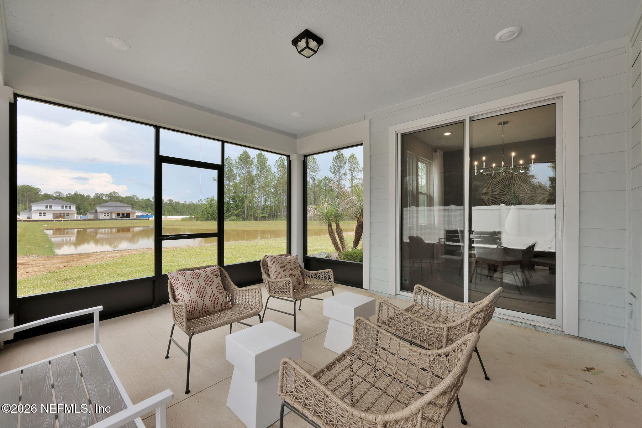 860 Rooster Holw Way Middleburg, FL 32068 - Photo 19 of 26 a living room with furniture and floor to ceiling windows