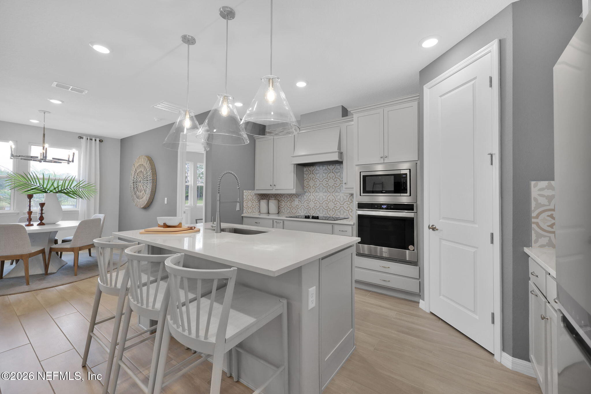 860 Rooster Holw Way Middleburg, FL 32068 - Photo 5 of 26 a large kitchen with kitchen island a large island in it
