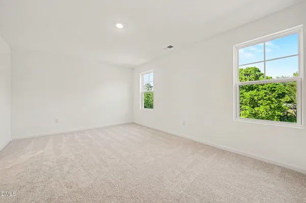 an empty room with windows and closet
