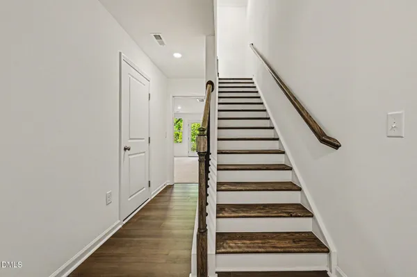 a view of entryway and hall with wooden floor