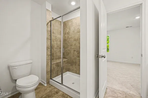 a bathroom with a shower and a toilet