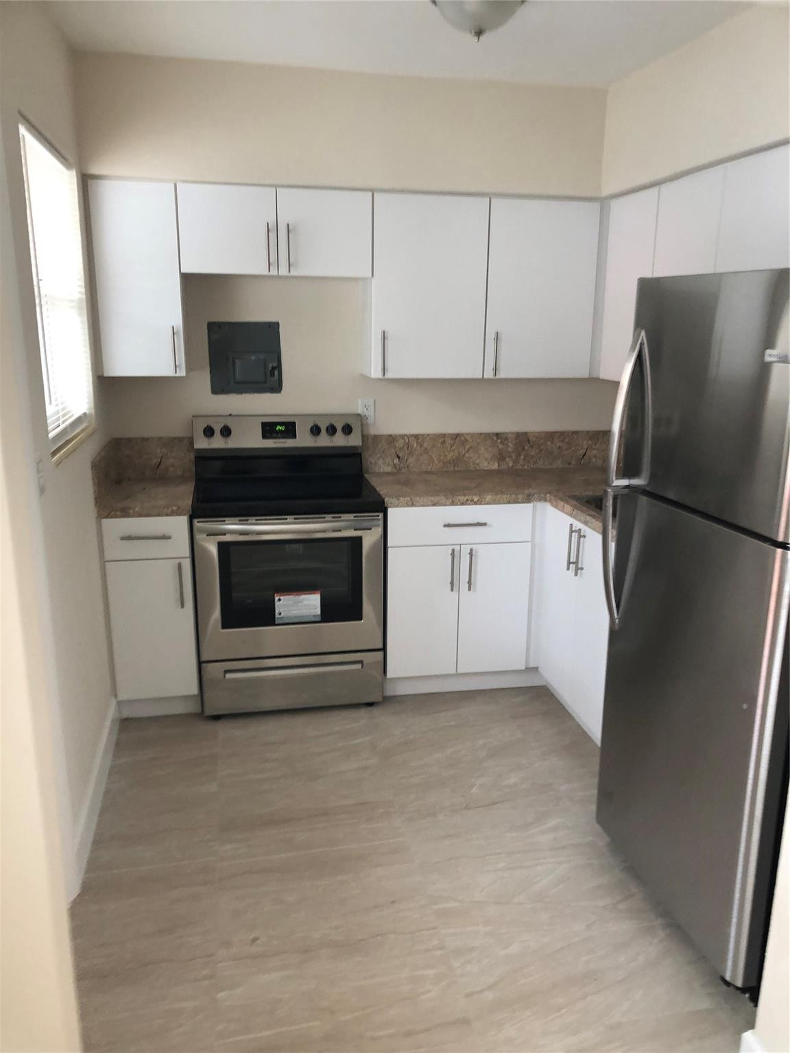 1575 Southwest 2nd Street, Unit 1 Miami, FL 33135 - Photo 6 of 10 a kitchen with granite countertop a sink stove and refrigerator