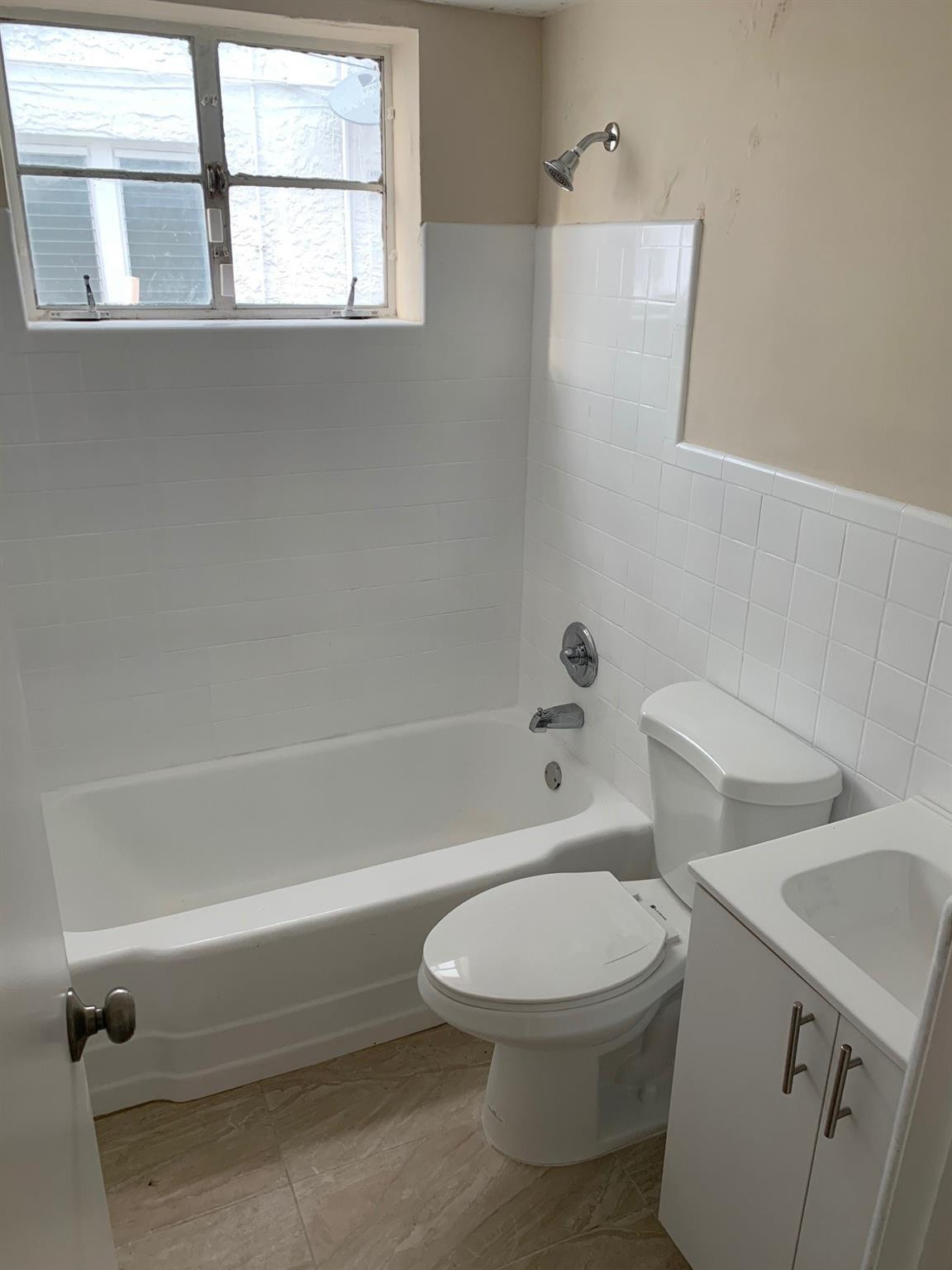 1575 Southwest 2nd Street, Unit 1 Miami, FL 33135 - Photo 9 of 10 a white toilet sitting next to a bath tub