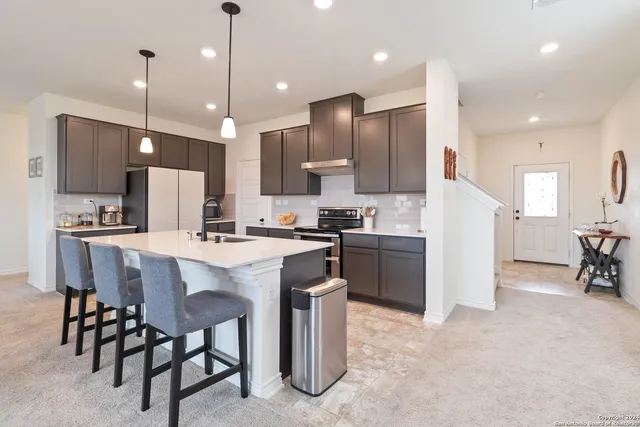 a large kitchen with a table and chairs
