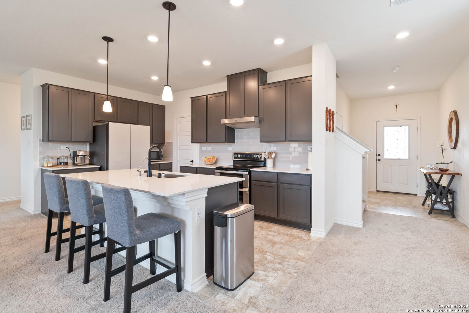 6611 Runaway Row Converse, TX 78109 - Photo 11 of 30 a large kitchen with a table and chairs