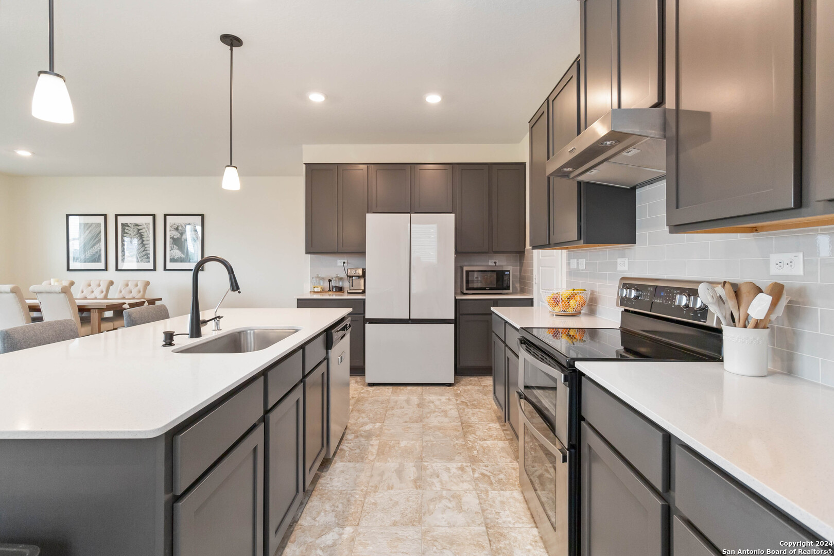 6611 Runaway Row Converse, TX 78109 - Photo 13 of 30 a kitchen with a sink refrigerator and cabinets
