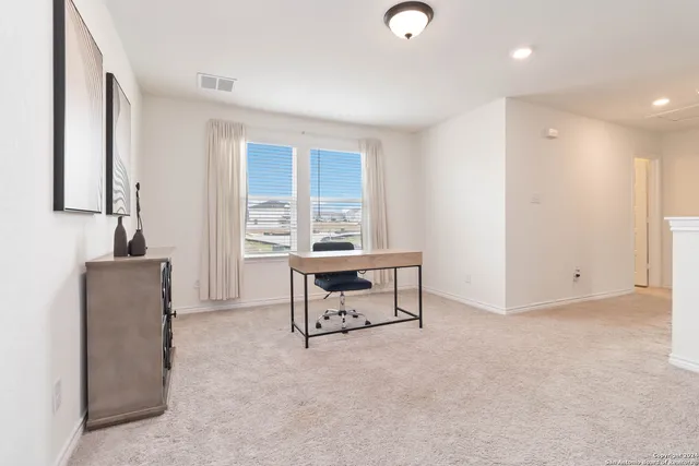 a living room with furniture a window and a fireplace