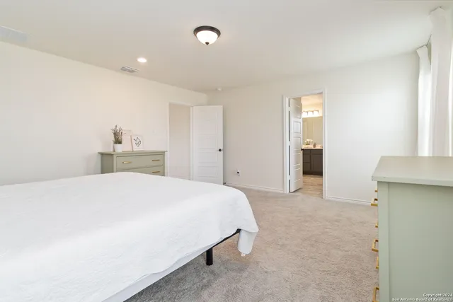 a bedroom with a bed and cabinets