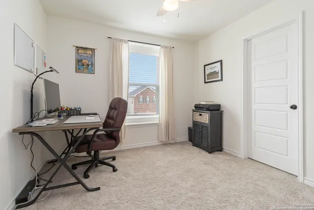 a view of a workspace with furniture