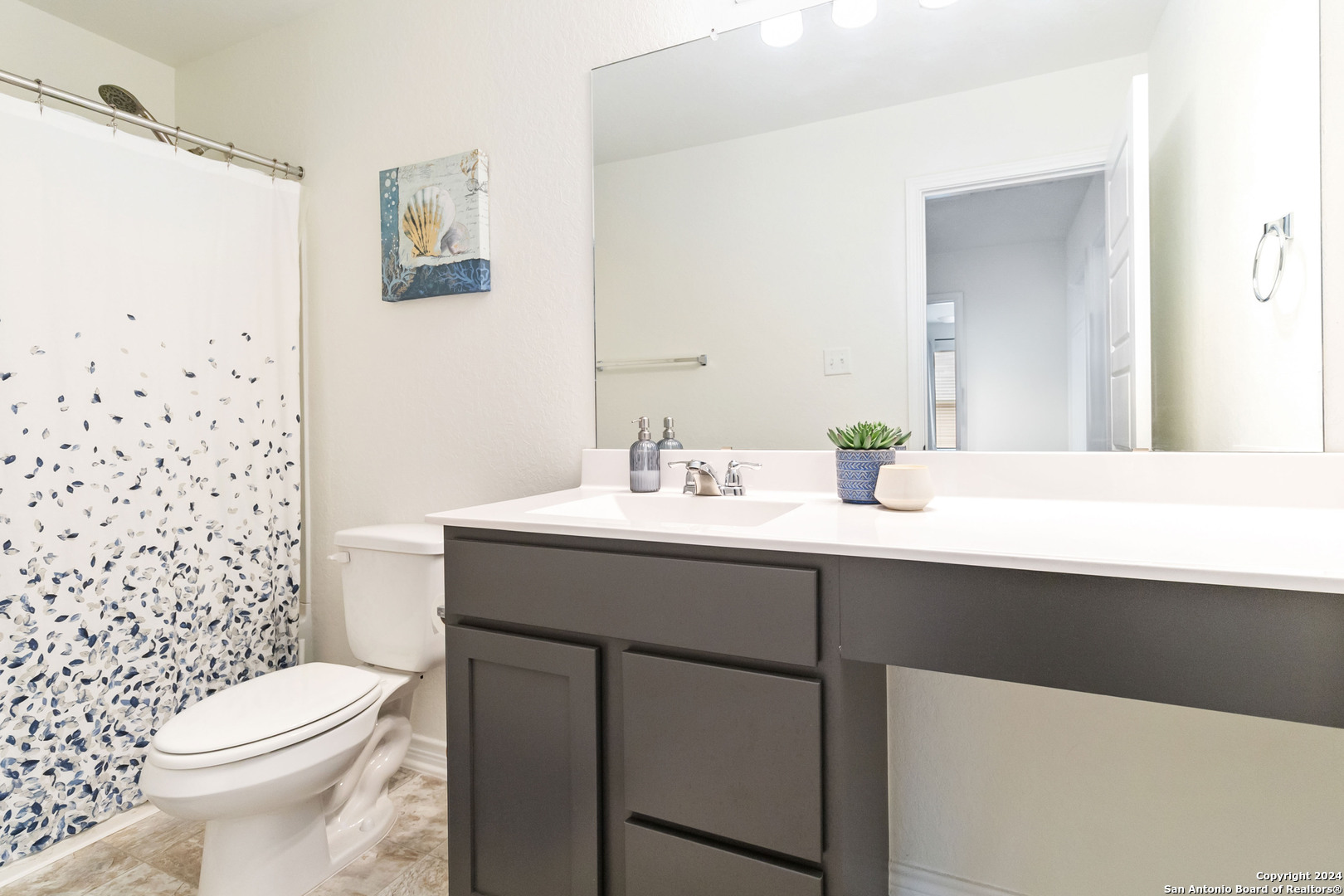 6611 Runaway Row Converse, TX 78109 - Photo 26 of 30 a bathroom with a sink a toilet and shower
