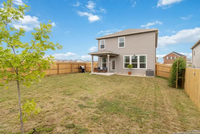 a view of a house with a backyard