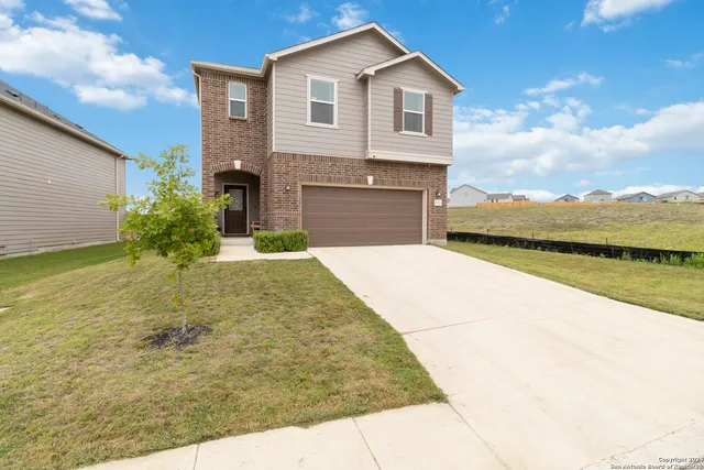 a front view of a house with a yard