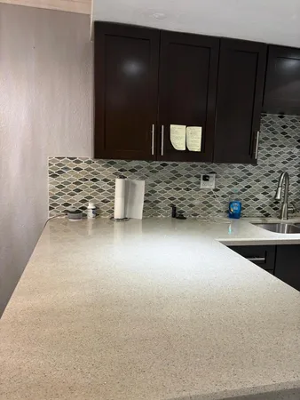 a view of kitchen with refrigerator and dining table