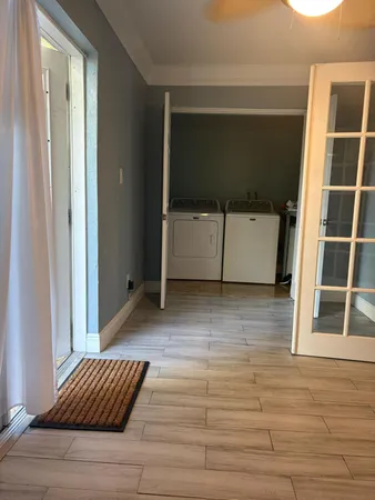 a view of a dining room with furniture and chandelier