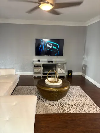 a living room with furniture and a wooden floor