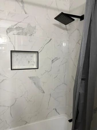 a bathroom with a shower and a mirror