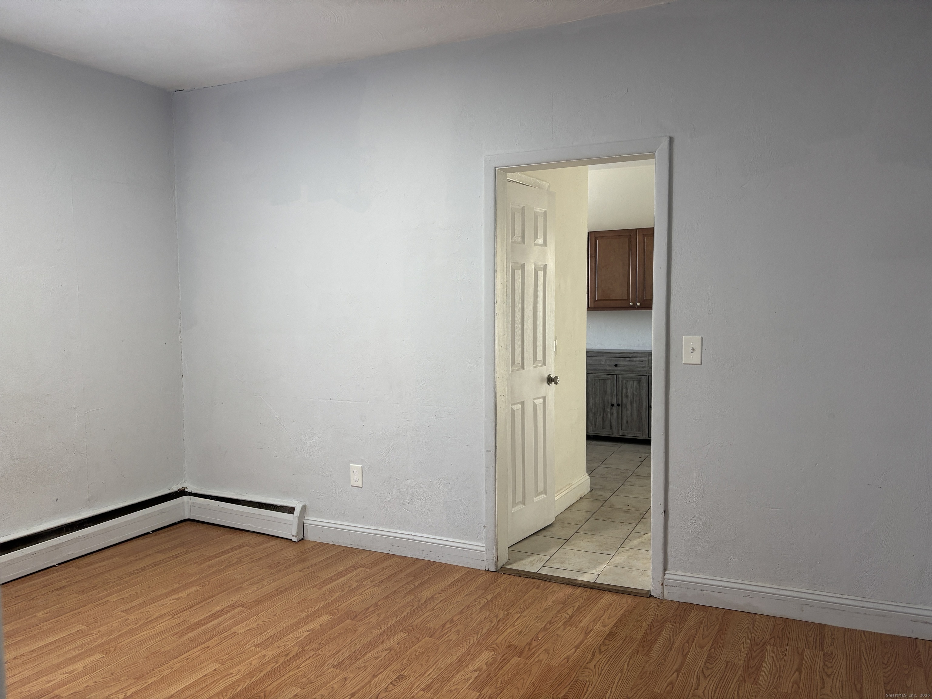 55 Bouton Street, Unit 1 Norwalk, CT 06854 - Photo 4 of 12 a view of an empty room with wooden floor and closet