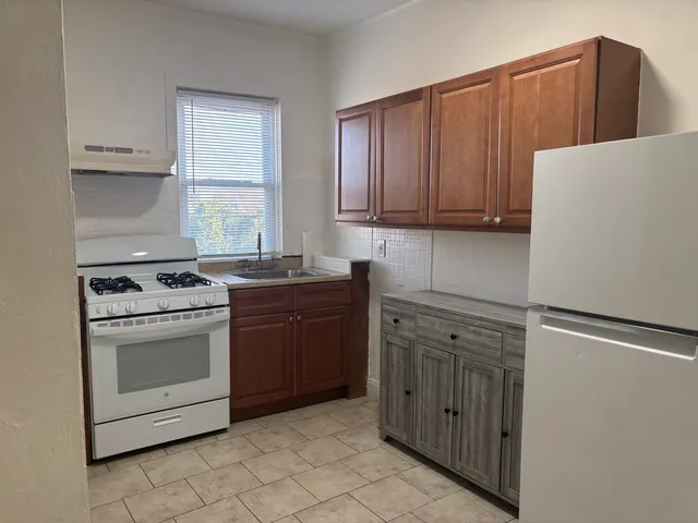 a kitchen with a stove sink and cabinets