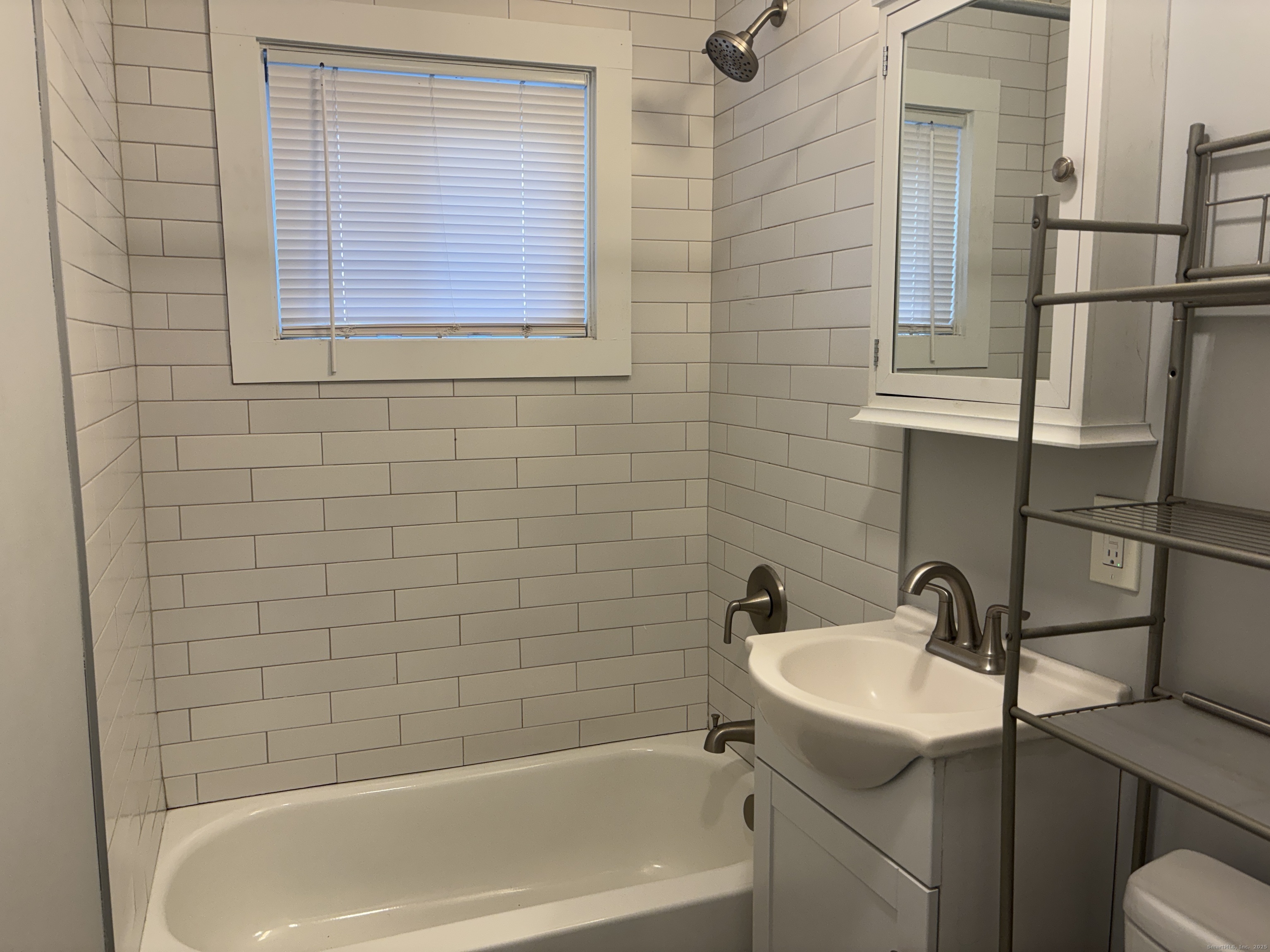55 Bouton Street, Unit 1 Norwalk, CT 06854 - Photo 10 of 12 a bathroom with a sink a bathtub and shower