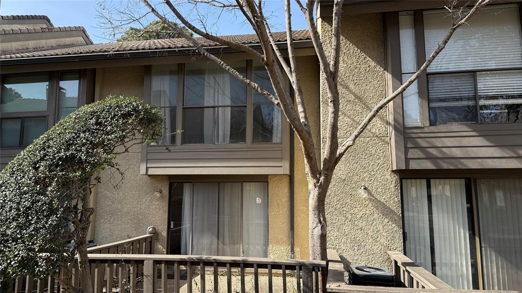 4531 North O'Connor Road, Unit 1196 Irving, TX 75062 - Photo 12 of 14 View of property exterior with stucco siding and a tile roof