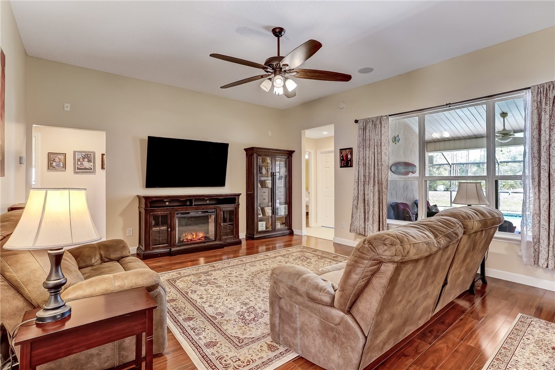 96356 Chester Road Yulee, FL 32097 - Photo 11 of 34 a living room with fireplace furniture and a flat screen tv
