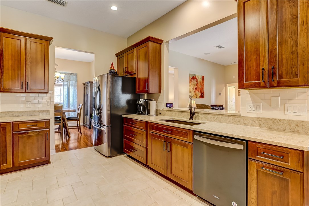 96356 Chester Road Yulee, FL 32097 - Photo 13 of 34 a kitchen with stainless steel appliances granite countertop a refrigerator and a sink