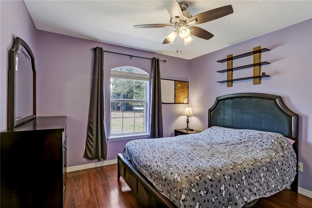 96356 Chester Road Yulee, FL 32097 - Photo 15 of 34 a bedroom with a large bed and a chandelier
