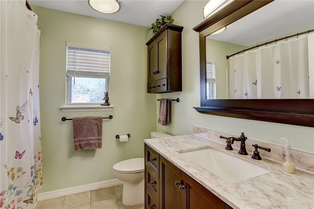 96356 Chester Road Yulee, FL 32097 - Photo 16 of 34 a bathroom with a granite countertop sink toilet and mirror