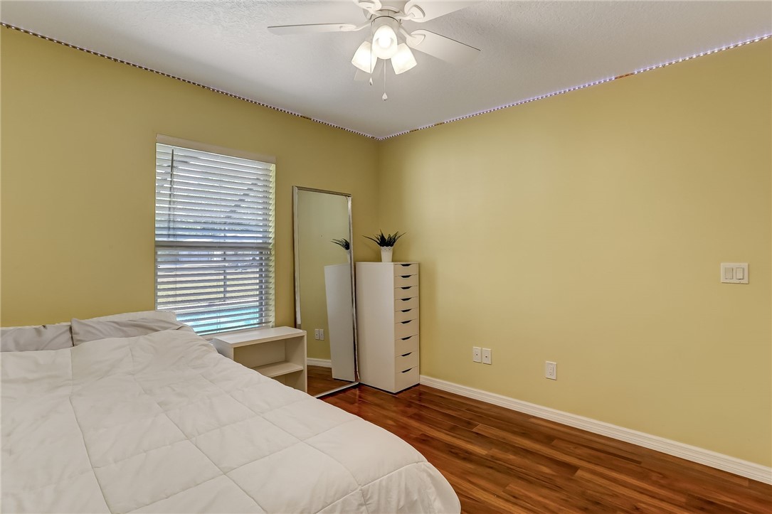 96356 Chester Road Yulee, FL 32097 - Photo 18 of 34 a bedroom with a bed and a chandelier