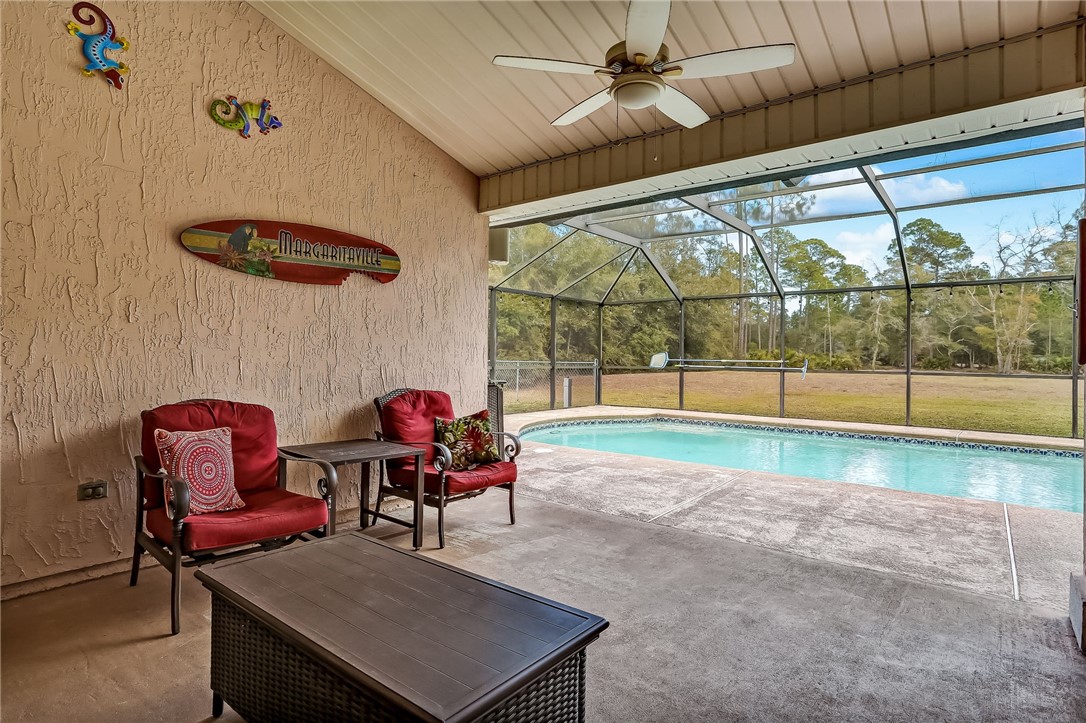96356 Chester Road Yulee, FL 32097 - Photo 25 of 34 a living room with furniture and a floor to ceiling window