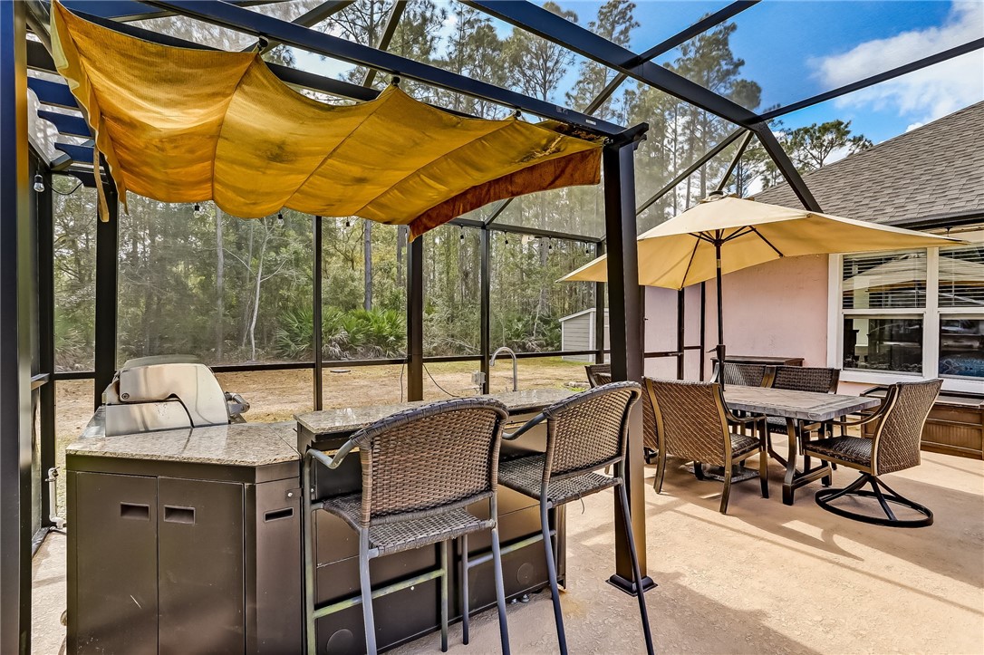 96356 Chester Road Yulee, FL 32097 - Photo 29 of 34 a view of an outdoor dining space with a table and chairs