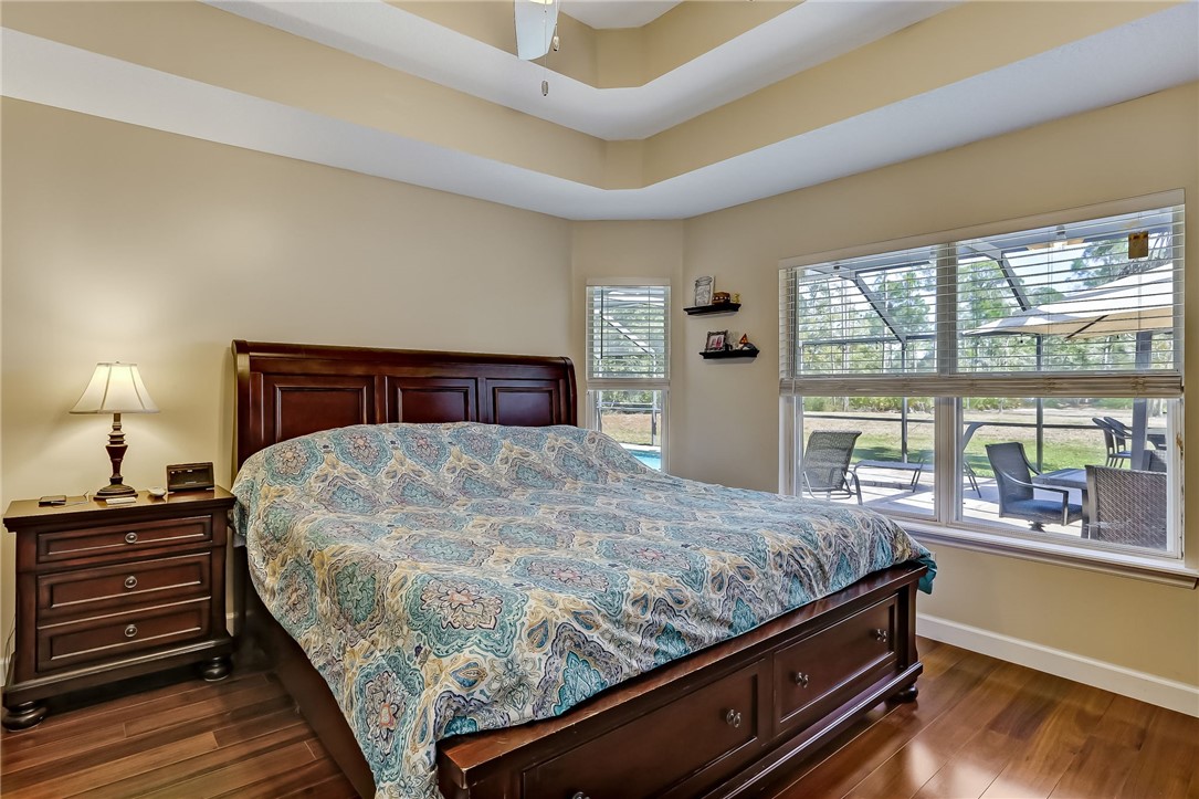 96356 Chester Road Yulee, FL 32097 - Photo 3 of 34 a bedroom with a bed and wooden floor