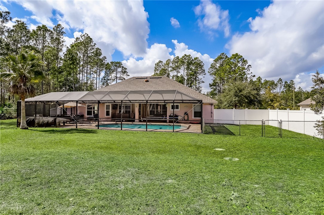 96356 Chester Road Yulee, FL 32097 - Photo 31 of 34 a swimming pool with outdoor seating and yard