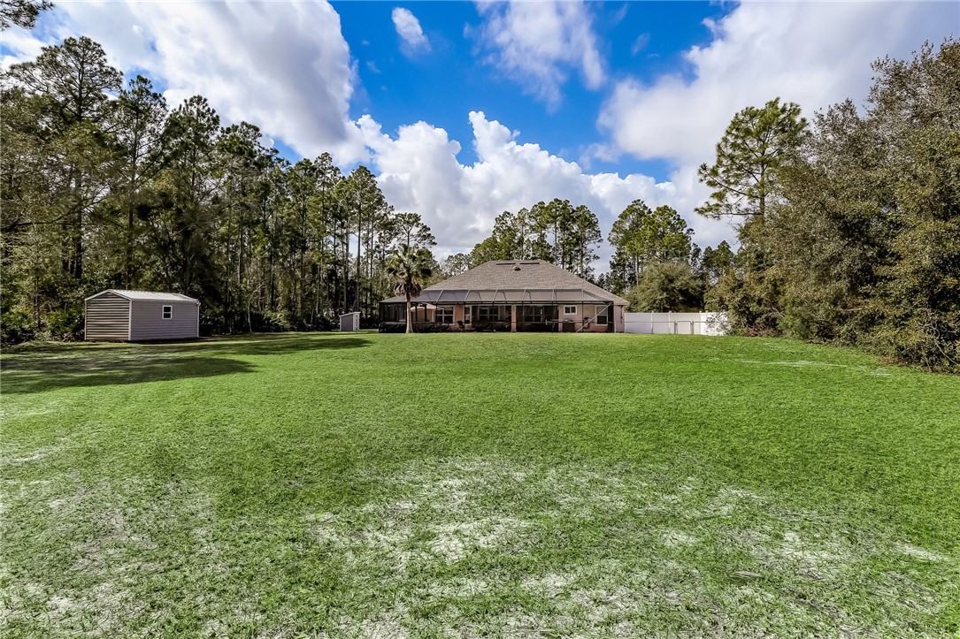 96356 Chester Road Yulee, FL 32097 - Photo 33 of 34 a front view of a house with garden