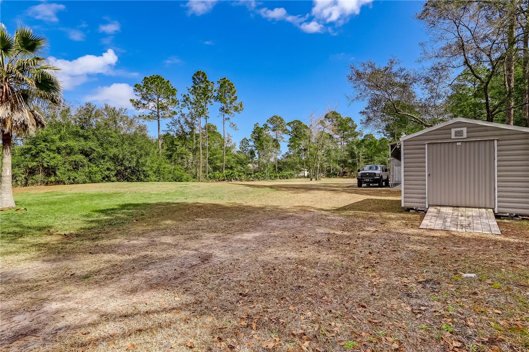 96356 Chester Road Yulee, FL 32097 - Photo 34 of 34 a backyard of a house with lots of green space