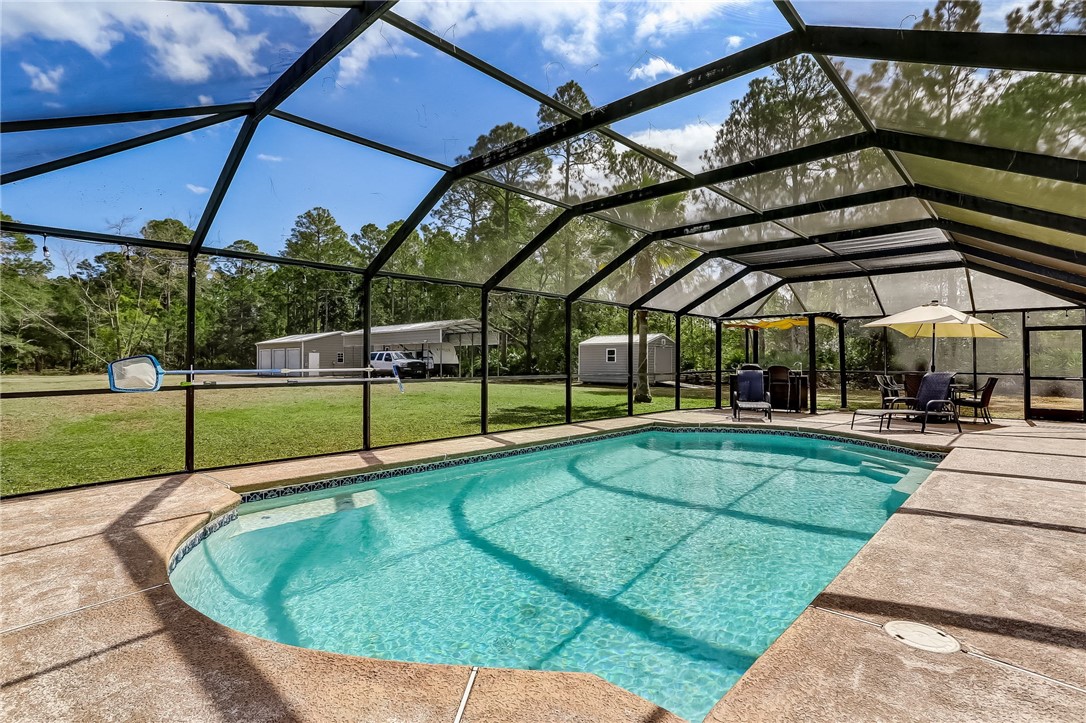 96356 Chester Road Yulee, FL 32097 - Photo 5 of 34 a view of a backyard with a swimming pool