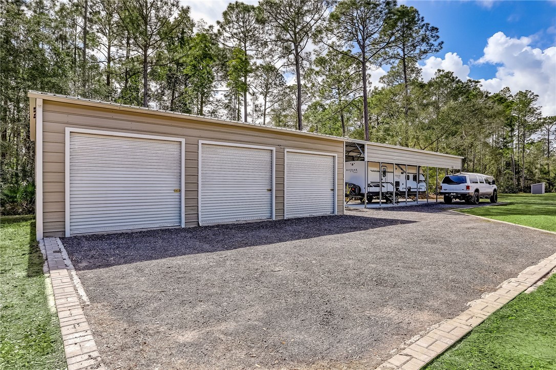 96356 Chester Road Yulee, FL 32097 - Photo 6 of 34 a view of garage with a car parked in it