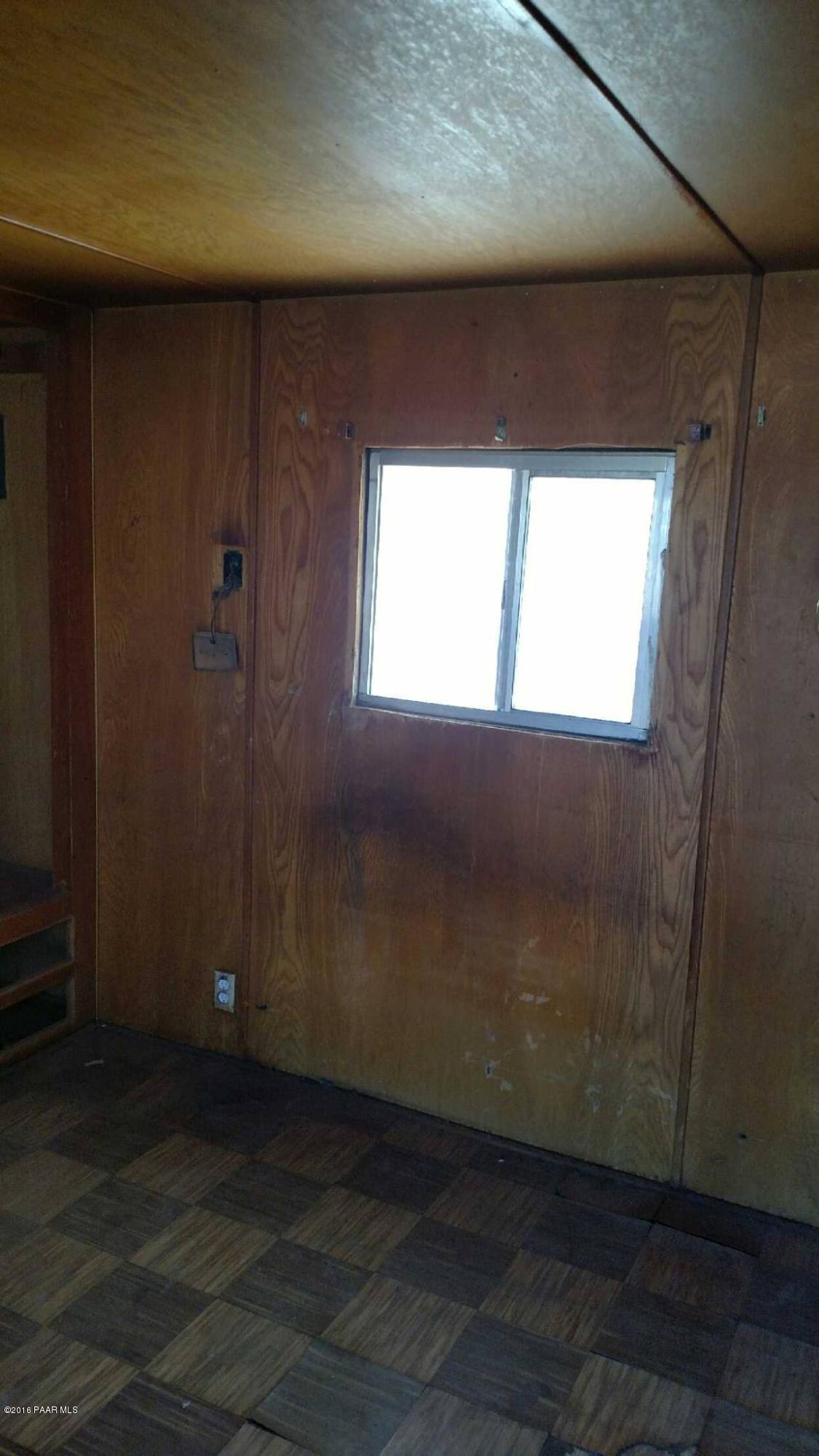 25480 North Mitchell Road Paulden, AZ 86334 - Photo 5 of 7 an empty room with wooden floor and windows