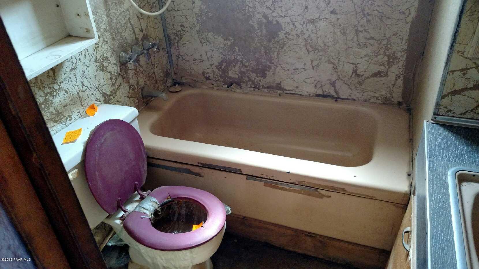 25480 North Mitchell Road Paulden, AZ 86334 - Photo 6 of 7 a bath tub sitting in a bathroom next to a toilet